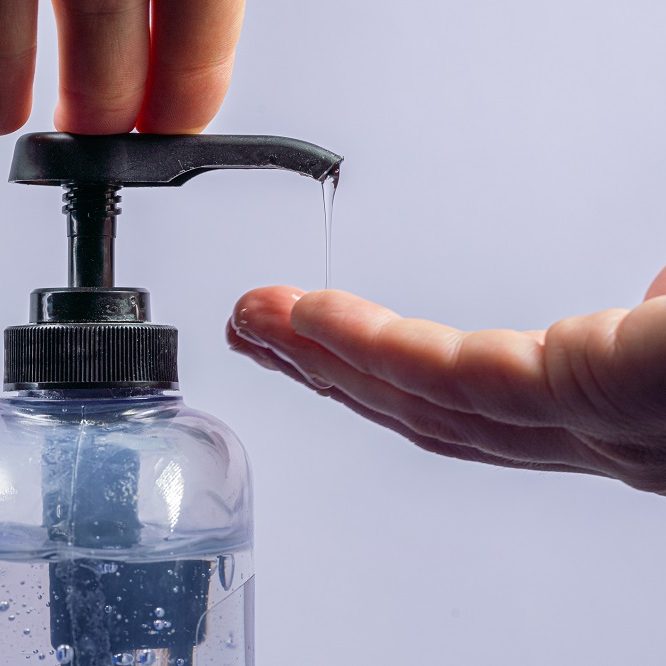 Close-Up Shot of Caucasian Male Hand Pumping Gel Hand Sanitizer with Alcohol and Aloe Vera To Prevent the Spread of COVID SARS nCoV 19 Coronavirus Swine Flu H7N9 Influenza Illness During Cold and Flu Season