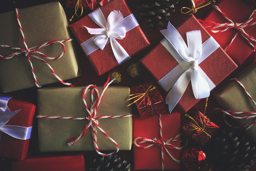 merry christmas gift box with white ribbon on red paper background. vintage tone and over light