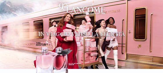 MIT2025-WK50-Lancome-HP-Grid-Banner.jpg Lancome La Vie Est Belle L’Elixir e Vanille Nude con confezioni regalo rosa su sfondo treno rosa e oro, testo In viaggio verso la felicità.