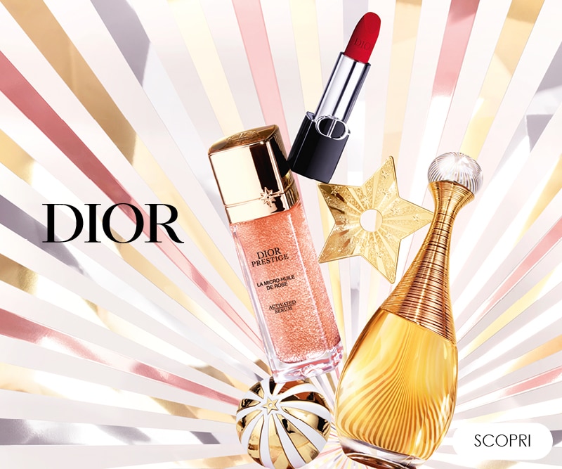MIT2025-WK51-Dior-HP-Banner.jpg Sfondo festivo con prodotti Dior, testo Scopri e decorazioni dorate a stella.