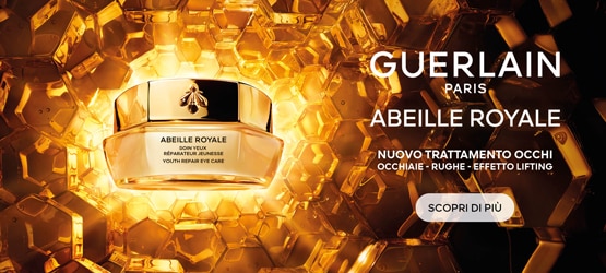 Crema contorno occhi Guerlain Abeille Royale su sfondo dorato a nido d’ape, evidenziando il nuovo trattamento lifting per occhiaie e rughe.
