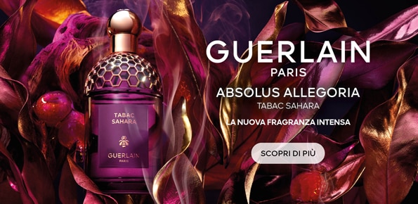 Boccetta del profumo Guerlain Absolus Allegoria Tabac Sahara tra foglie dorate, nuova fragranza intensa.