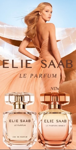 Elie Saab Le Parfum con due flaconi eleganti su sfondo dorato e abito lungo color pesca, nuova fragranza.