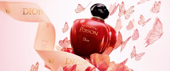 Profumo Dior Hypnotic Poison in flacone rosso con decorazioni floreali.