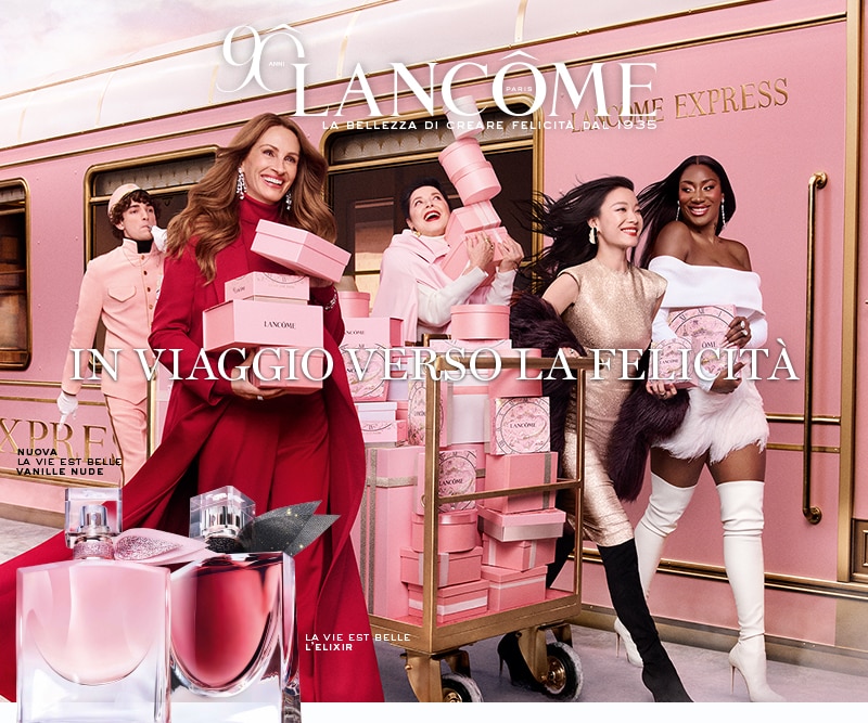 Lancome La Vie Est Belle L’Elixir e Vanille Nude con confezioni regalo rosa su sfondo treno rosa e oro, testo In viaggio verso la felicità.