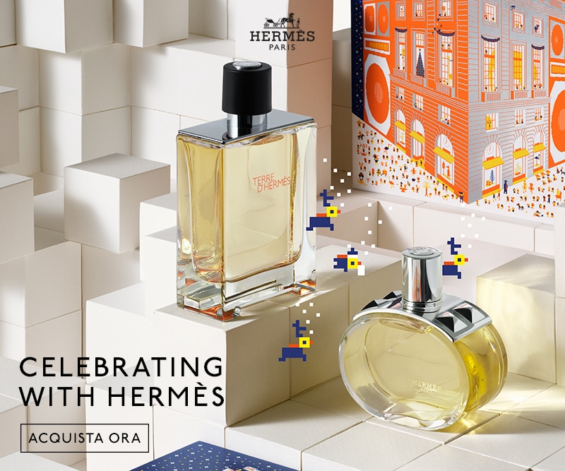 Flaconi Hermès su sfondo bianco con testo Celebrating With Hermès e pulsante Acquista Ora.